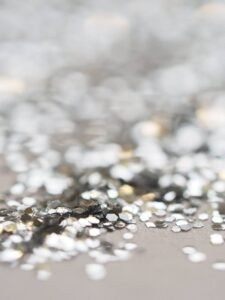 Home 17 A Close Up Of Silver Glitter On A Table